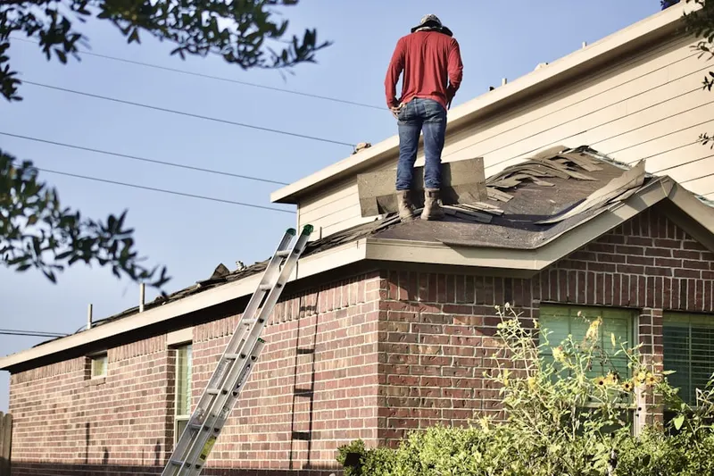 Professional roofer working on a residential roof in Port Washington North